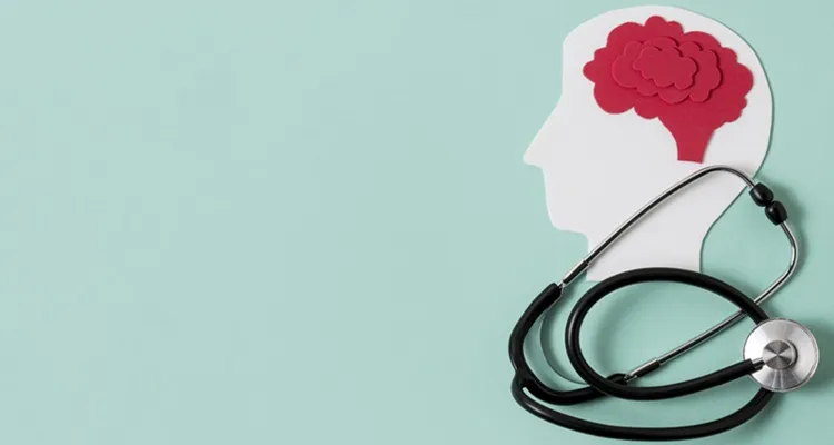 Vignette Actualité - Une silhouette blanche de tête humaine sur fond bleu clair, avec un cerveau rouge et un stéthoscope noir symbolisant la santé mentale ou cérébrale.