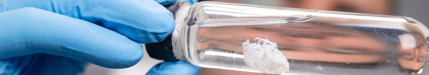 Une homme tenant un flacon de thérapie génique développé dans un des laboratoires de l'AFM-Téléthon