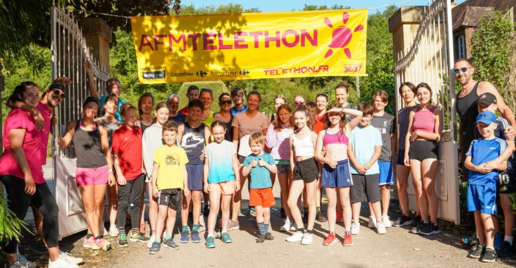 des participants au téléthon camping posent avec une banderole